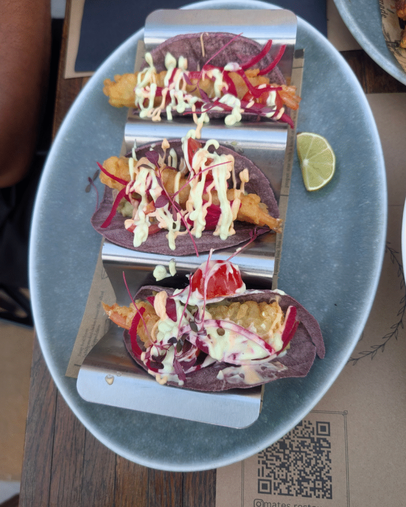 Tempura prawn tacos with guacamole, pickled red onions, and avocado mayo at Mate’s Restaurant.