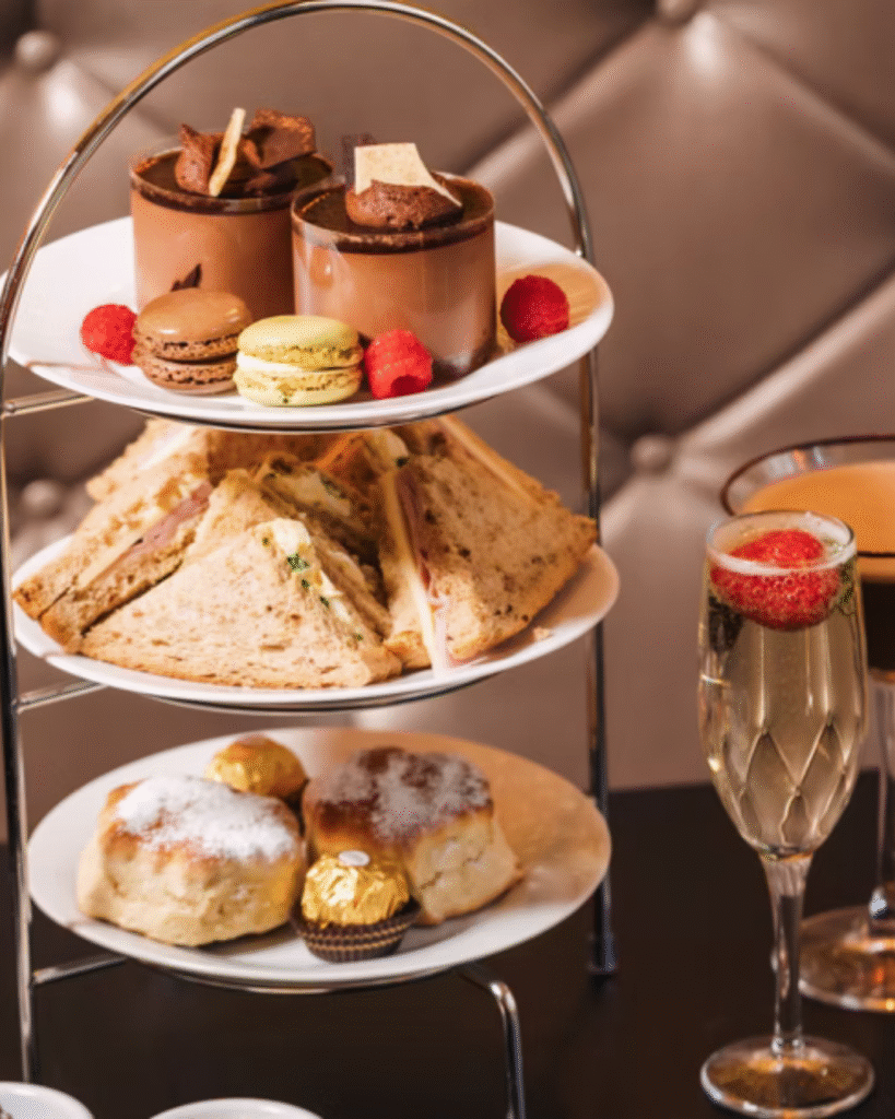 Afternoon tea stand with chocolate cocktails, sandwiches, and cakes at The Chocolate Cocktail Club